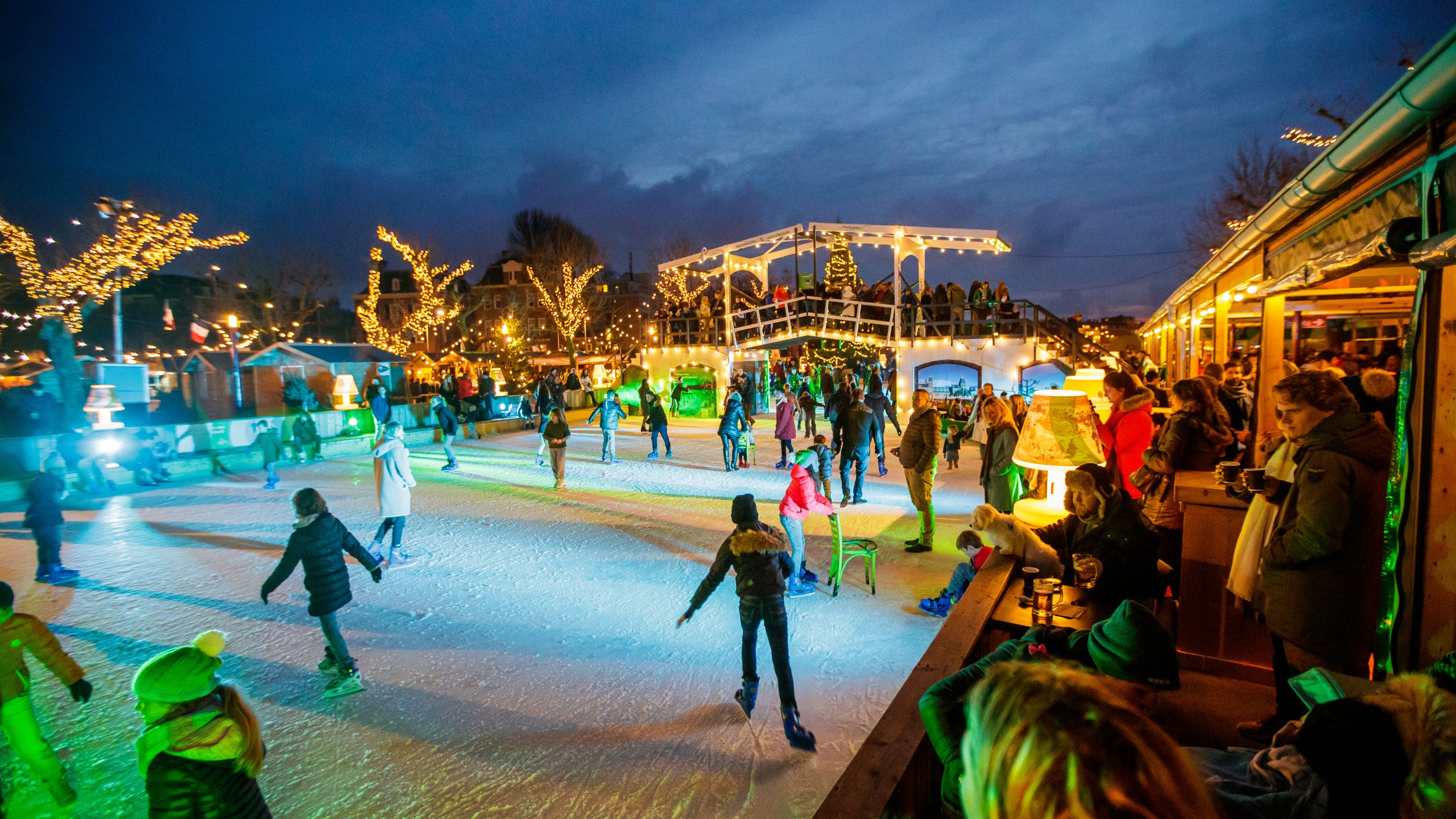 Outdoor ice rink at Museumplein Amsterdam in winter, with the Rijksmuseum in the background